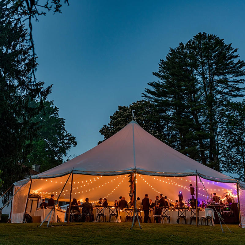 Sailcloth Event Tent by Canvas Camp Luxury Outdoor Canopy at night dusk with lights