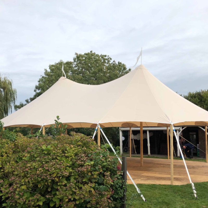 Sailcloth Event Tent by Canvas Camp Luxury Outdoor Canopy during the day behind a bush