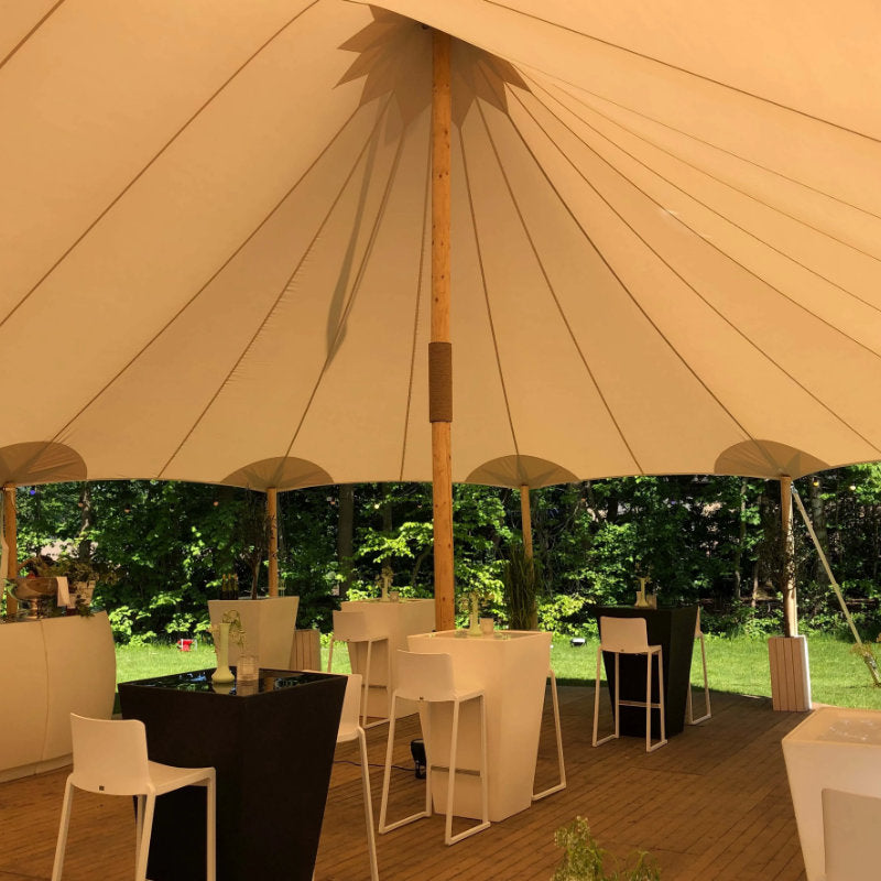 Sailcloth Event Tent by Canvas Camp Luxury Outdoor Canopy interior view of ceiling and pole with black and white table and chairs