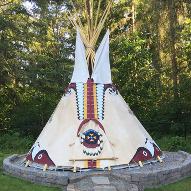 Teepee Tent by Nomadic Tipi Makers Anasazi Inspiration design on stone platform in woods