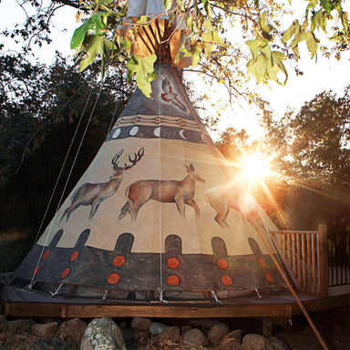 Teepee Tent by Nomadic Tipi Makers Buck and Doe's design rear view on deck with sunset
