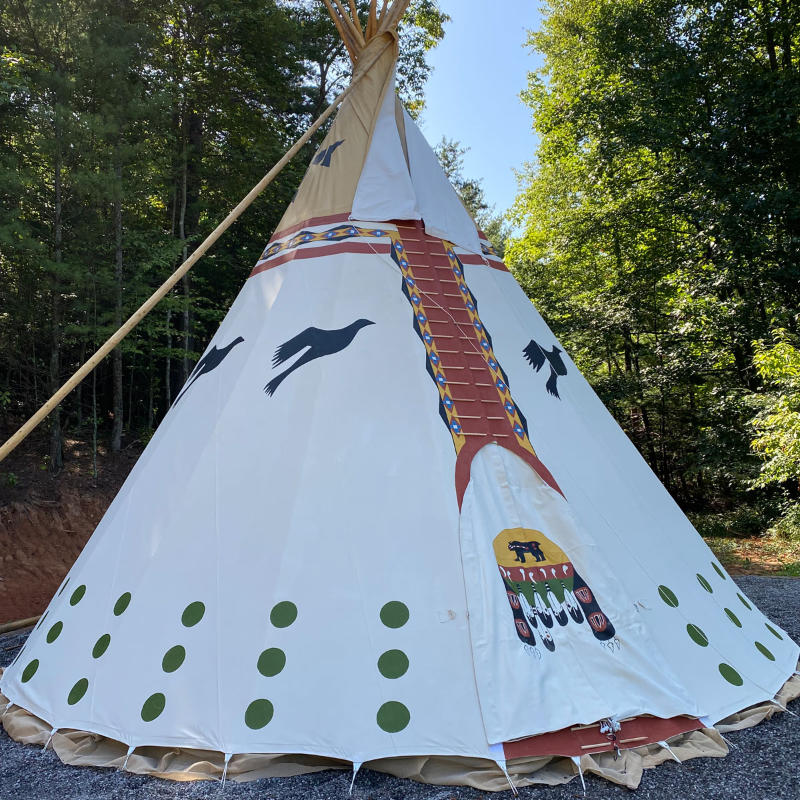 Teepee Tent by Nomadic Tipi Makers The Four Direction design front right view on gravel in forest