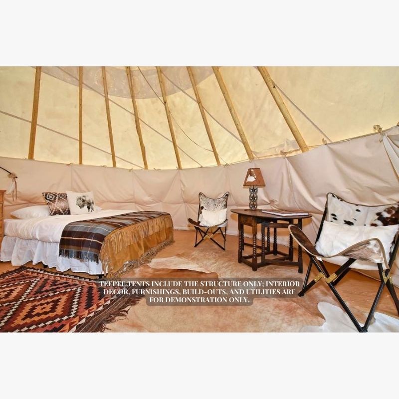 Teepee Tent by Nomadic Tipi Makers interior view with bed two camping chairs and a table