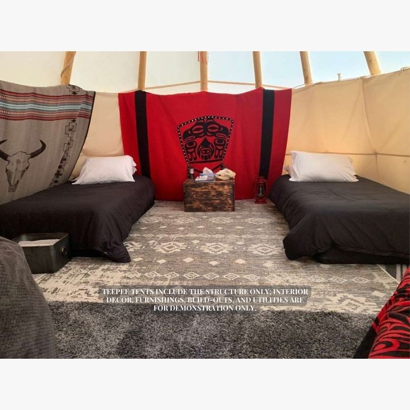 Teepee Tent by Nomadic Tipi Makers interior view with two beds black comforters and rugs