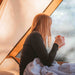 A Frame Tent Big Horn by Canvas Camp interior view woman drinking coffee