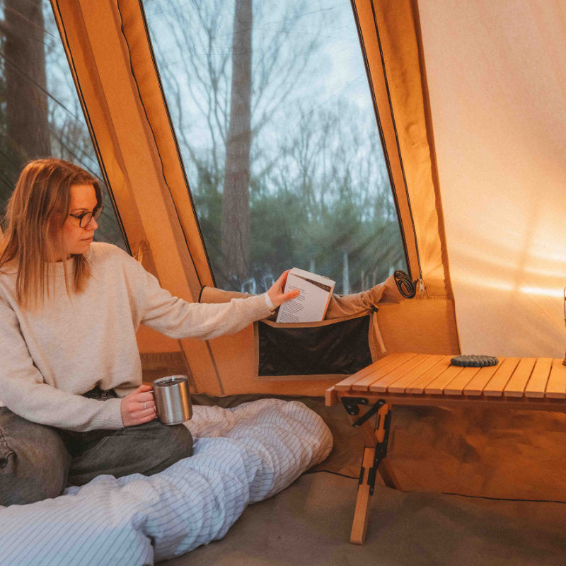 A Frame Tent Big Horn by Canvas Camp woman drinking coffee and storage pockets