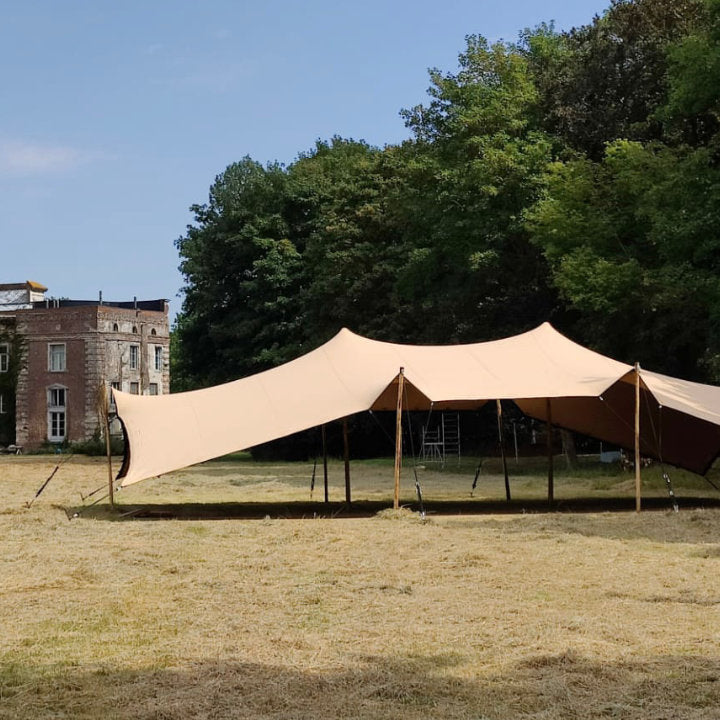 Flex Stretch Tent Q3 by Canvas Camp Luxury Outdoor Canopy on brown grass sunny day trees and building in background