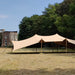 Flex Stretch Tent Q3 by Canvas Camp Luxury Outdoor Canopy on brown grass sunny day trees and building in background