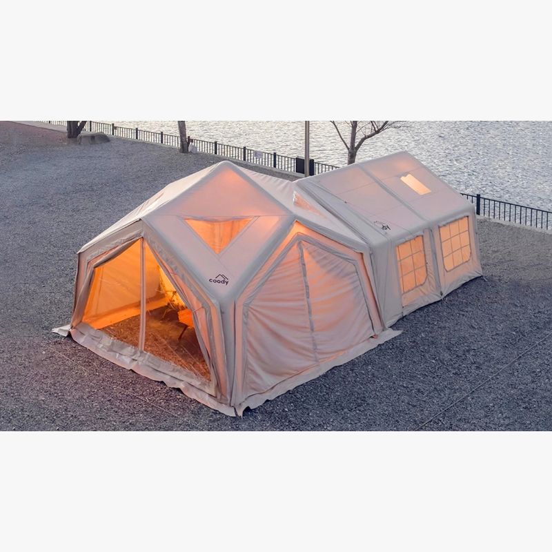 RBM Koala Hub beige at dusk with lights on rocks by river