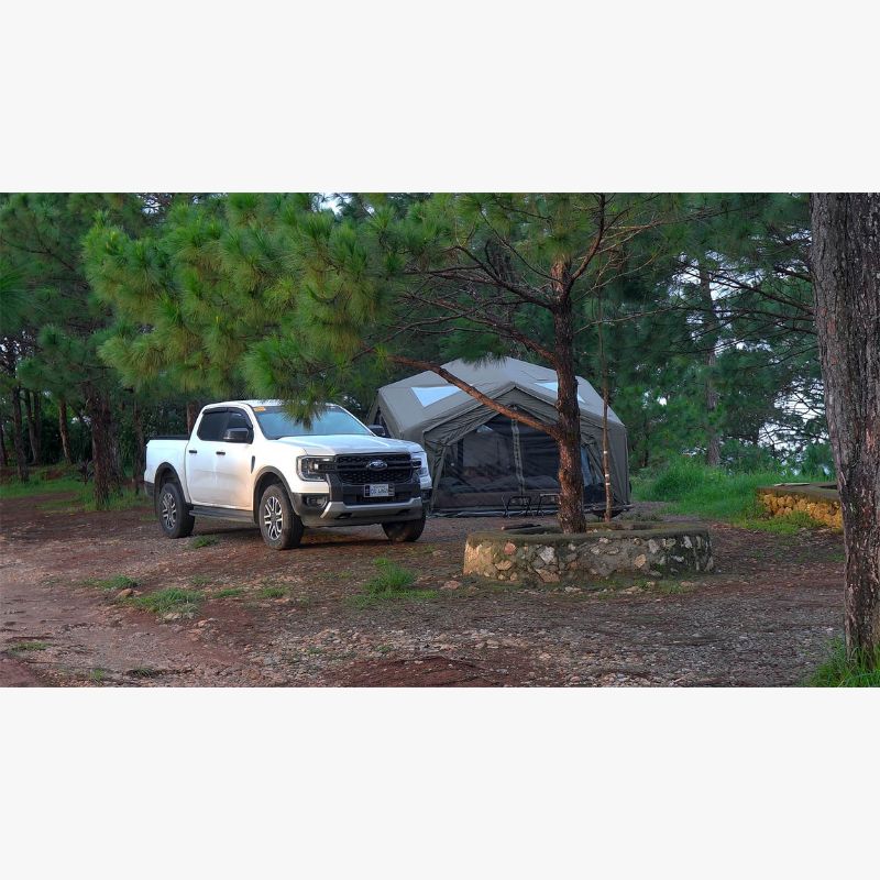 RBM Koala Hub khaki at campsite in woods with white truck