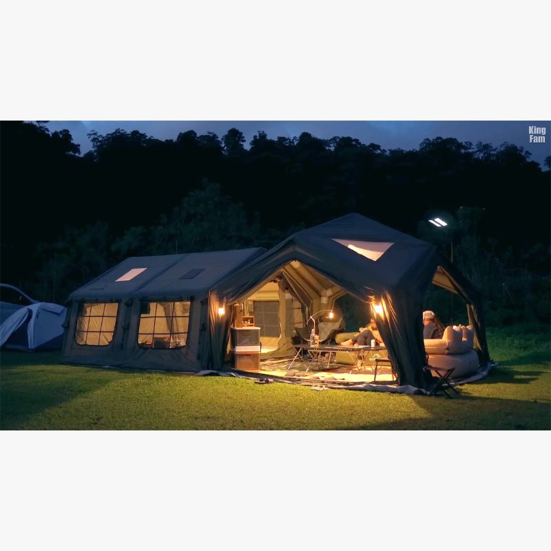 RBM Koala Hub khaki at night with lights and doors open people on couch