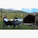 RBM Koala Hub khaki by mountains with man sitting in camp chair