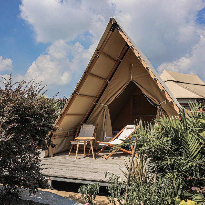 Safari Tent Equinox I by Luna Glamping front left view with two chairs on deck