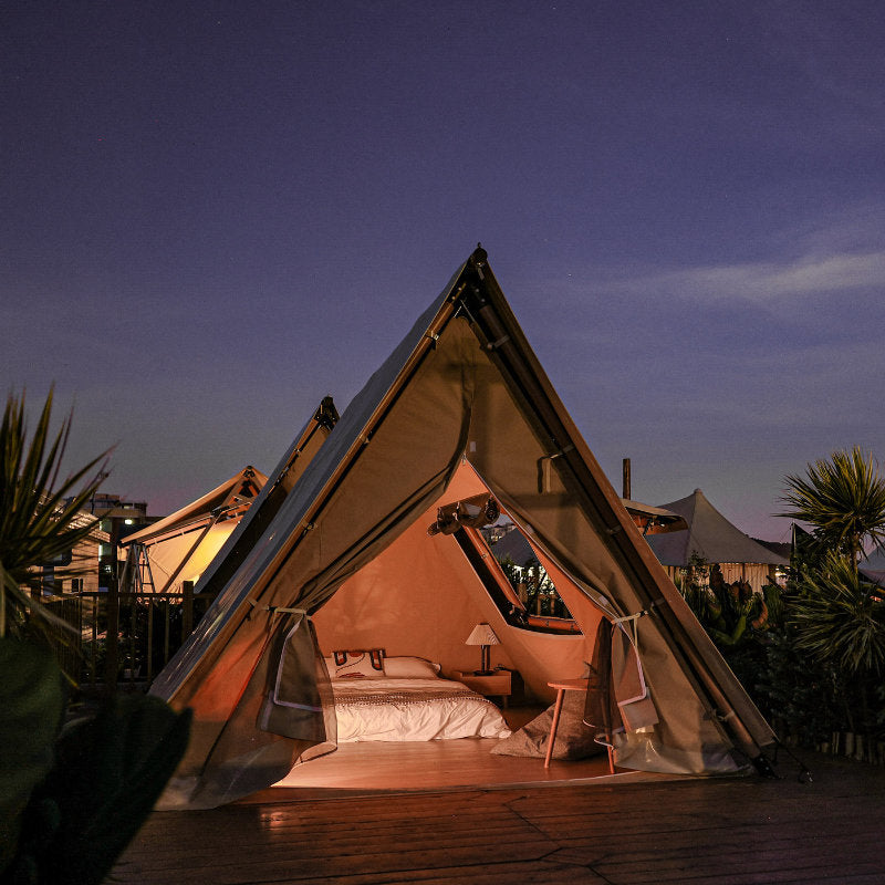 Safari Tent Equinox I by Luna Glamping front view of interior at night