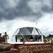 Stargazing Dome 19' Luna Glamping in white by stone wall