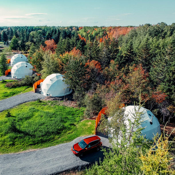 Stargazing Dome 19' Luna Glamping white drone view of four domes