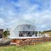 Stargazing Dome 19' Luna Glamping white front view on wood deck