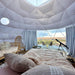 Stargazing Dome 23' Luna Glamping interior view two pink beds and telescope