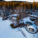 Stargazing Dome 23' Luna Glamping white drone view in forest with snow on concrete slab