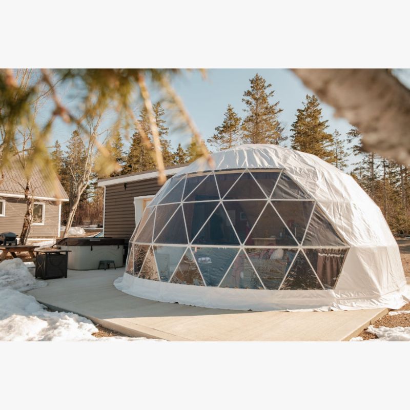 Stargazing Dome 23' Luna Glamping white front left view with snow in woods and hot tub daytime