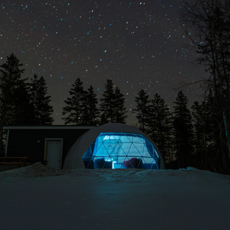 Stargazing Dome 23' Luna Glamping white in snow at night with blue light