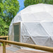 Stargazing Dome 26' Luna Glamping in white front entrance view on wood deck in forest