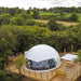 Stargazing Dome 26' Luna Glamping in white front view on wood deck daytime