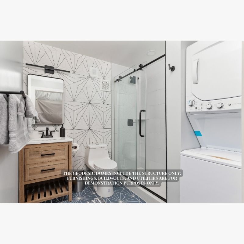 Stargazing Dome 26' Luna Glamping in white interior view of bathroom with washer dryer shower toilet and sink
