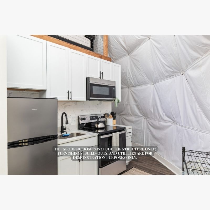 Stargazing Dome 26' Luna Glamping in white interior view of kitchen with fridge sink and oven