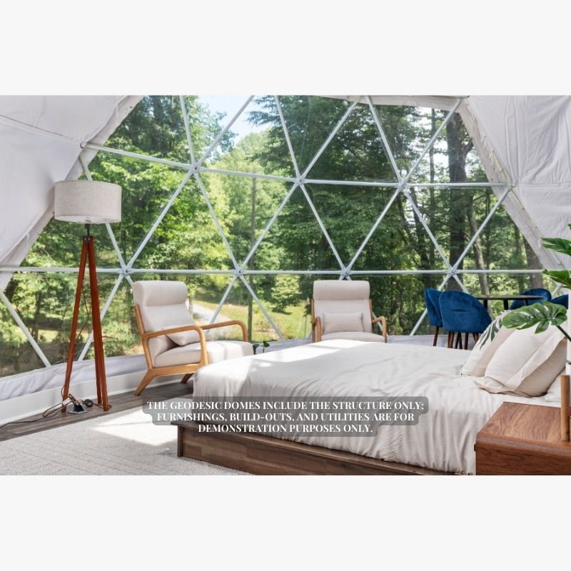 Stargazing Dome 26' Luna Glamping in white interior view with bed two chairs and lamp