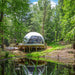 Stargazing Dome 26' Luna Glamping in white on wood deck by pond