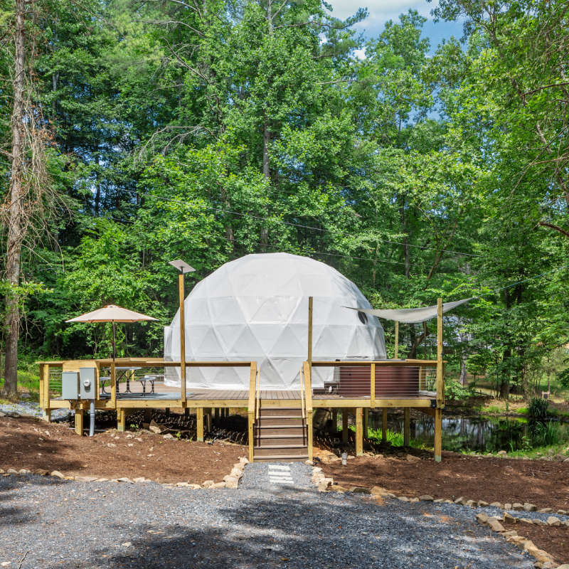 Stargazing Dome 26' Luna Glamping in white on wood deck in forest