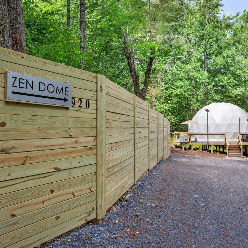 Stargazing Dome 26' Luna Glamping in white on wood deck in forest zen dome