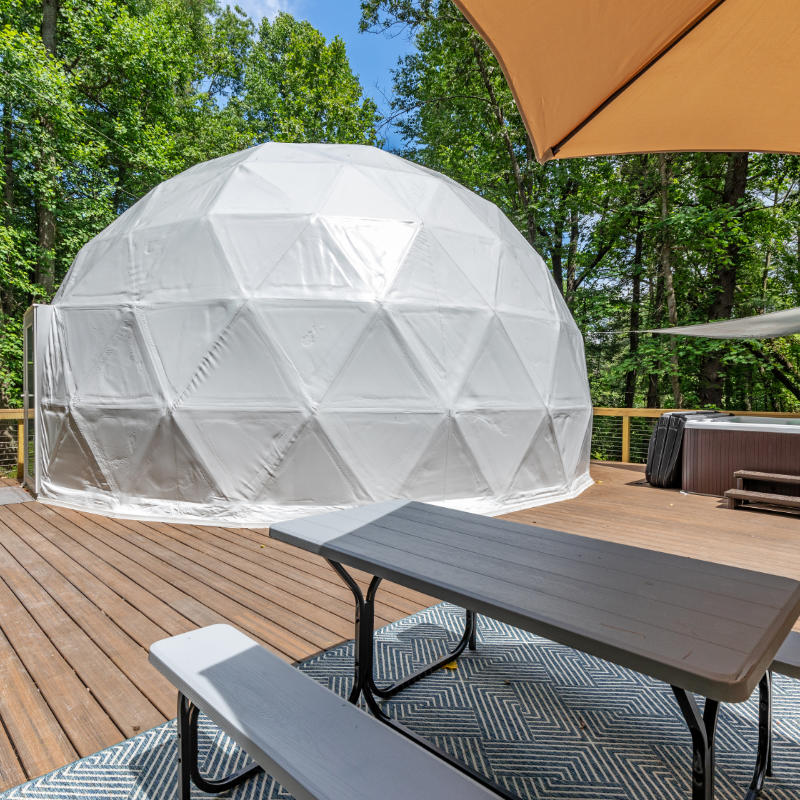 Stargazing Dome 26' Luna Glamping in white on wood deck with picnic table and hot tub in forest