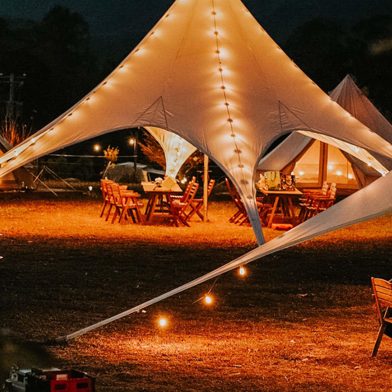 Starshade Event Tent by CanvasCamp  Luxury Outdoor Canopy at night with lights at a party