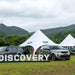 Starshade Event Tent by CanvasCamp  Luxury Outdoor Canopy land rover discovery with four land rovers on grass