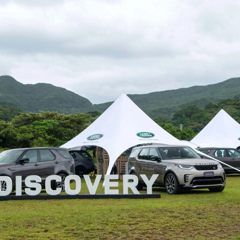 Starshade Event Tent by CanvasCamp  Luxury Outdoor Canopy land rover discovery with four land rovers on grass