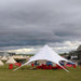 Starshade Event Tent by CanvasCamp  Luxury Outdoor Canopy nissan with red bean bag chairs on grass
