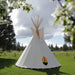 Teepee Tent by Nomadic Tipi Makers in white front view on grass