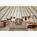 Teepee Tent by Nomadic Tipi Makers interior view with fire pit two beds and rugs