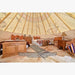 Teepee Tent by Nomadic Tipi Makers interior view with two beds and two chairs with bison pillows