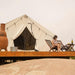 Wall Tent Canvas Camp woman on deck reading with grapes and wine
