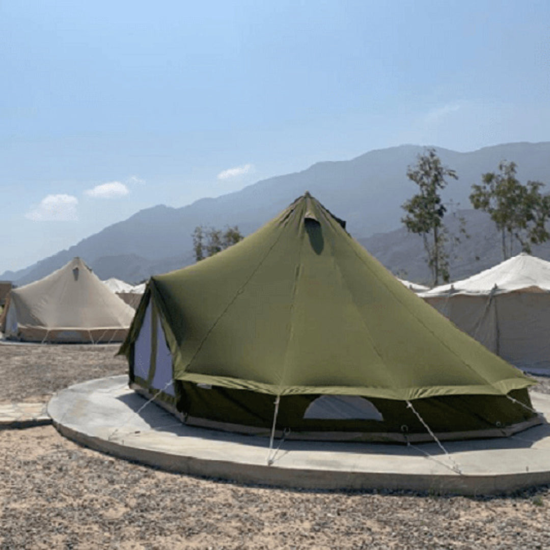 Yurt Tent Sibley Pro 500 by Canvas Camp Green on concrete platform at resort sunny day