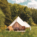 Yurt Tent Sibley Pro 500 by Canvas Camp on wood deck in grassy field
