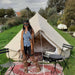 Yurt Tent Sibley Ultimate 300 by Canvas Camp with woman on red rug by a river