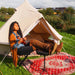 Yurt Tent Sibley Ultimate 300 by Canvas Camp woman sitting in chair with feet up and red rug
