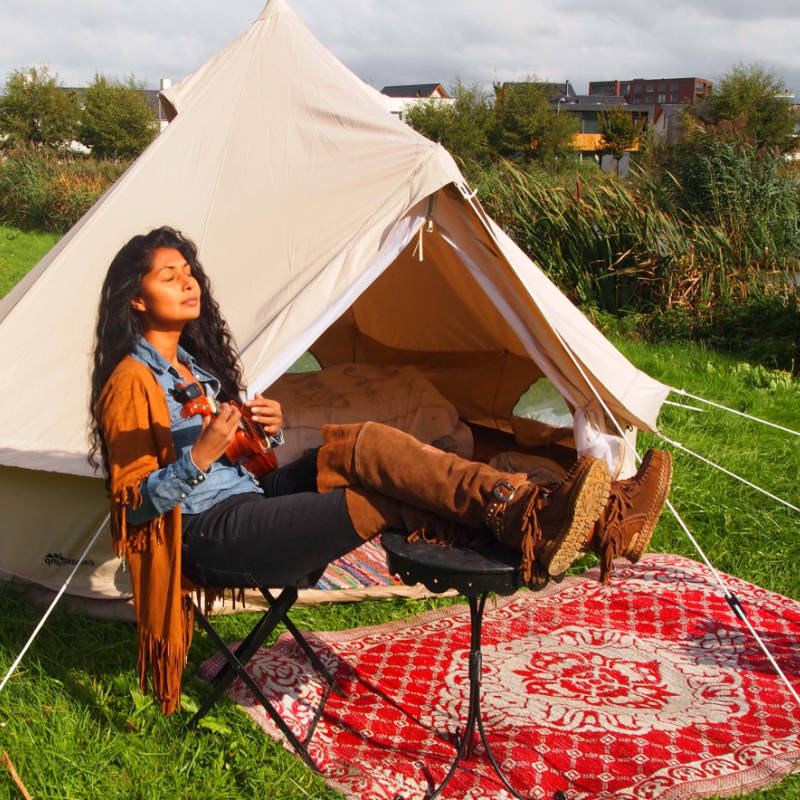 Yurt Tent Sibley Ultimate 300 by Canvas Camp woman sitting in chair with feet up and red rug