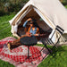 Yurt Tent Sibley Ultimate 300 by Canvas Camp woman sitting in doorway with red rug playing ukulele guitar instrument