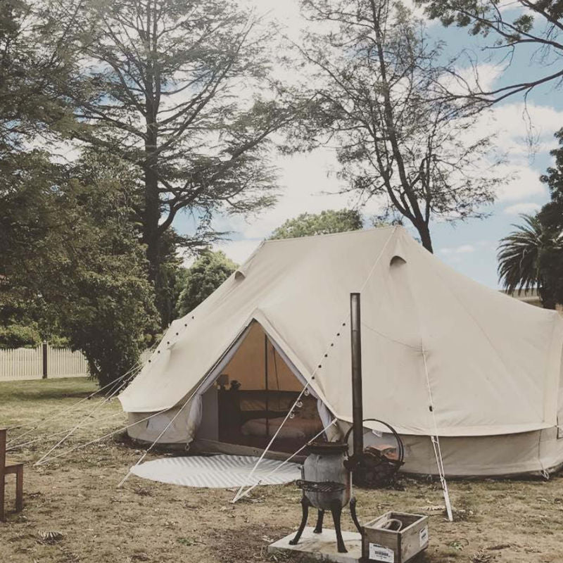 Yurt Tent Sibley Ultimate 600 twin by Canvas Camp at campsite with wood stove and pile of wood