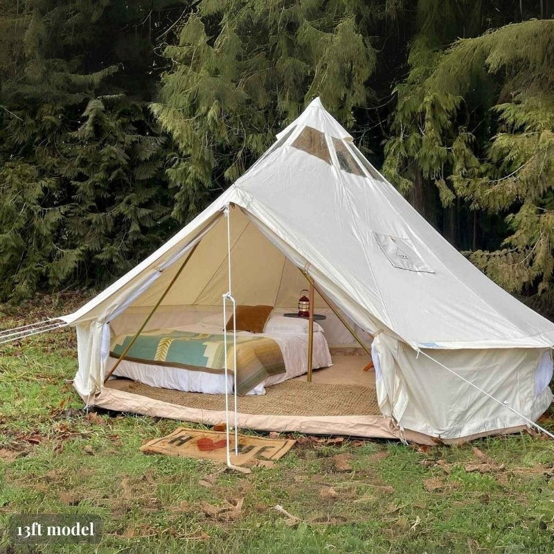 Yurt Tent Stella Stargazer by Life in Tents 13ft front left view on grass near trees with home door mat
